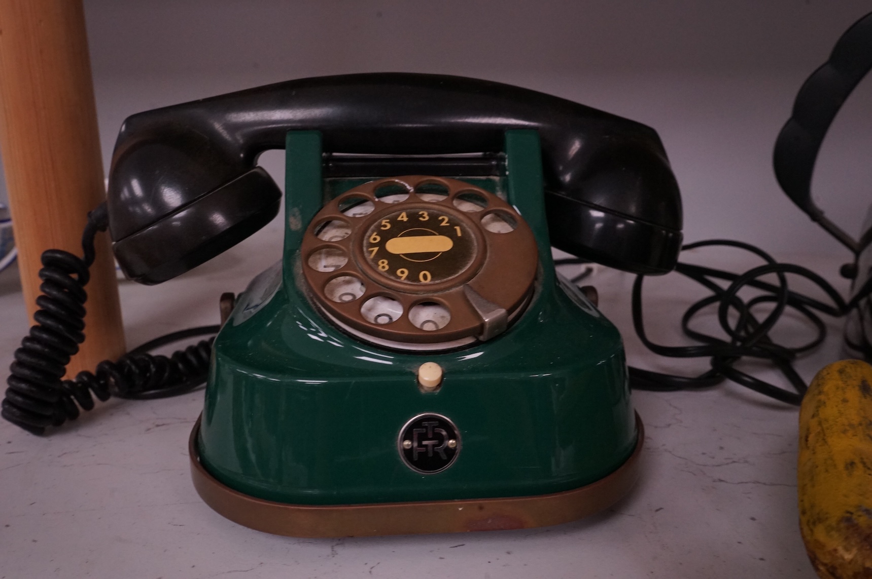An Alessi 9091 kettle by Richard Sapper, an FTR green telephone and a painted cast iron mechanical money box. (3). Alessi kettle 22cm high.